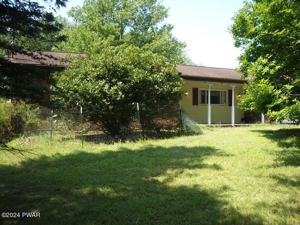 81 Tuthill Road Waymart, PA 18472 - Photo 25 of 29 a backyard of a house with yard and outdoor seating
