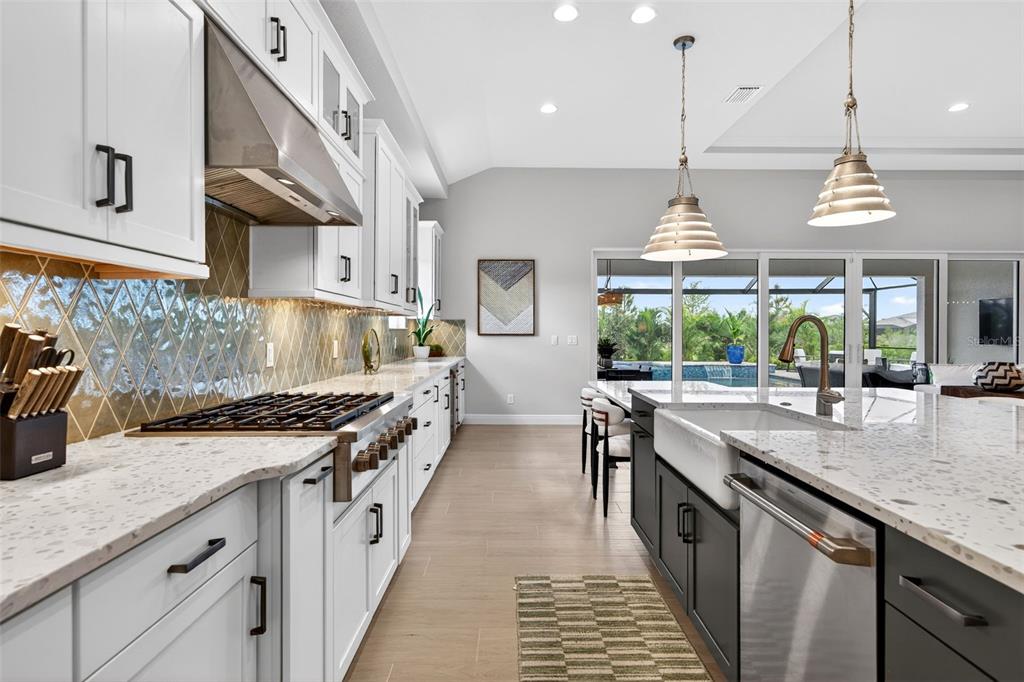 11523 Gleaming Terrace Venice, FL 34293 - Photo 23 of 83 a kitchen with stainless steel appliances granite countertop a sink a stove and a wooden floors