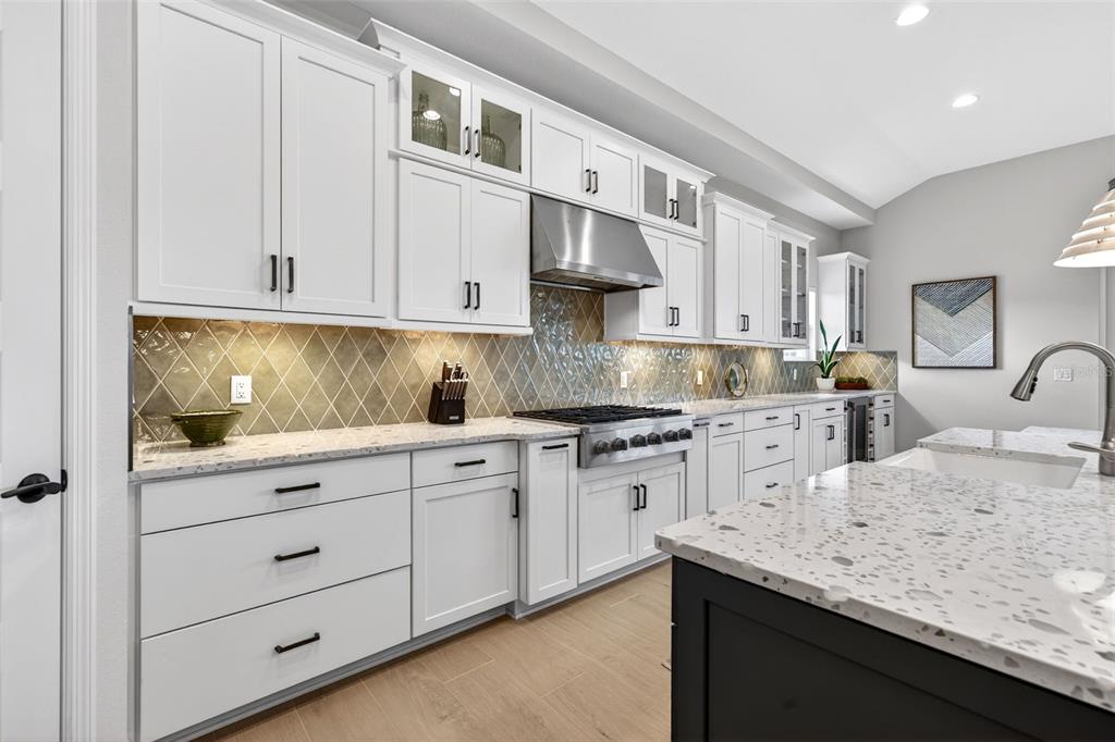 11523 Gleaming Terrace Venice, FL 34293 - Photo 24 of 83 a kitchen with granite countertop white cabinets and white appliances