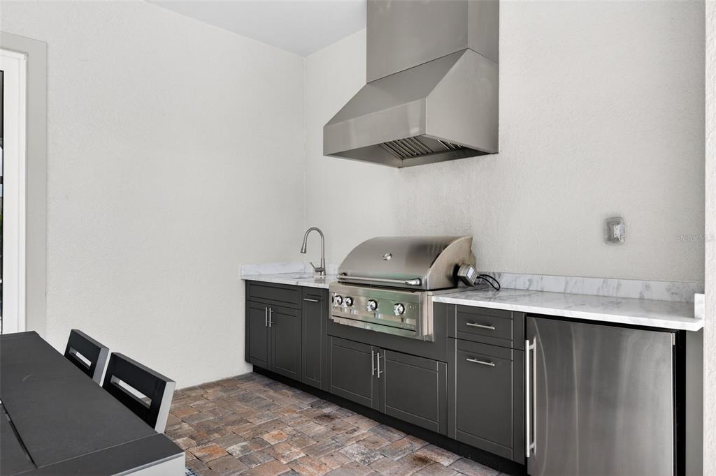 11523 Gleaming Terrace Venice, FL 34293 - Photo 34 of 83 a kitchen with stainless steel appliances granite countertop a sink stove and refrigerator