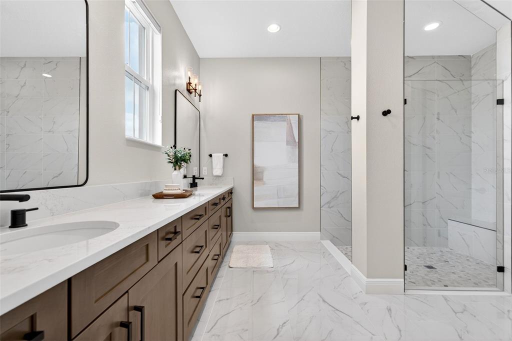 11523 Gleaming Terrace Venice, FL 34293 - Photo 44 of 83 a spacious bathroom with a double sink shower and a mirror