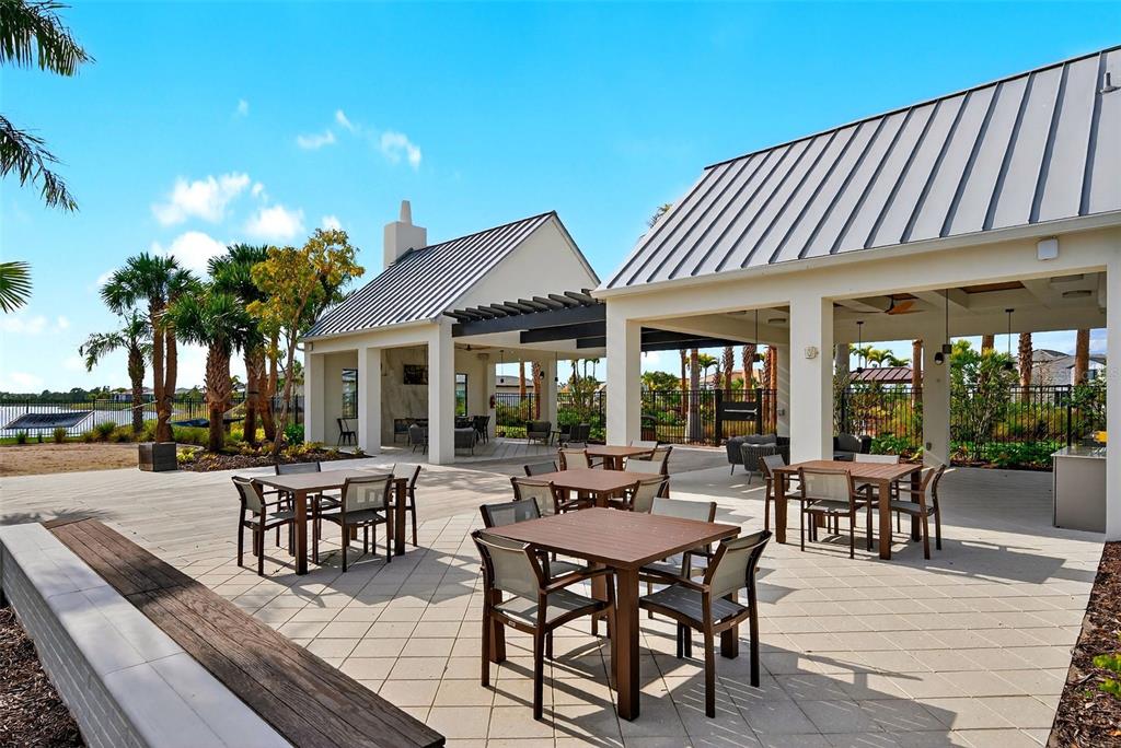 11523 Gleaming Terrace Venice, FL 34293 - Photo 68 of 83 a view of a patio with table and chairs and potted plants