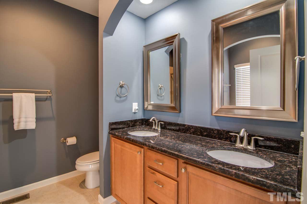 1308 Cornell Place Raleigh, NC 27607 - Photo 14 of 25 a bathroom with a granite countertop sink and a mirror