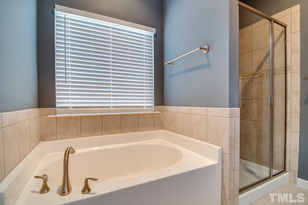1308 Cornell Place Raleigh, NC 27607 - Photo 15 of 25 a bathroom with a bathtub and a shower