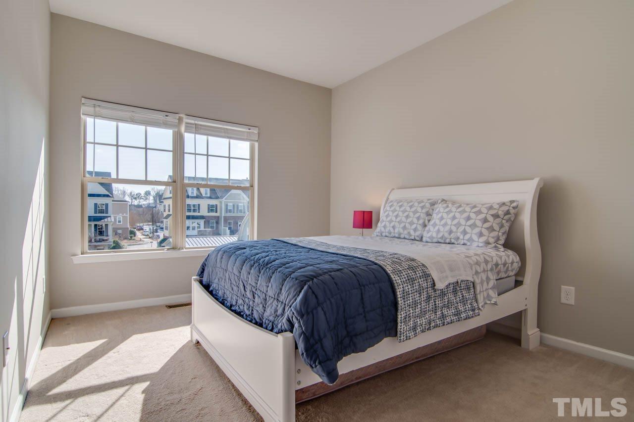 1308 Cornell Place Raleigh, NC 27607 - Photo 16 of 25 a spacious bedroom with a bed lamp and window