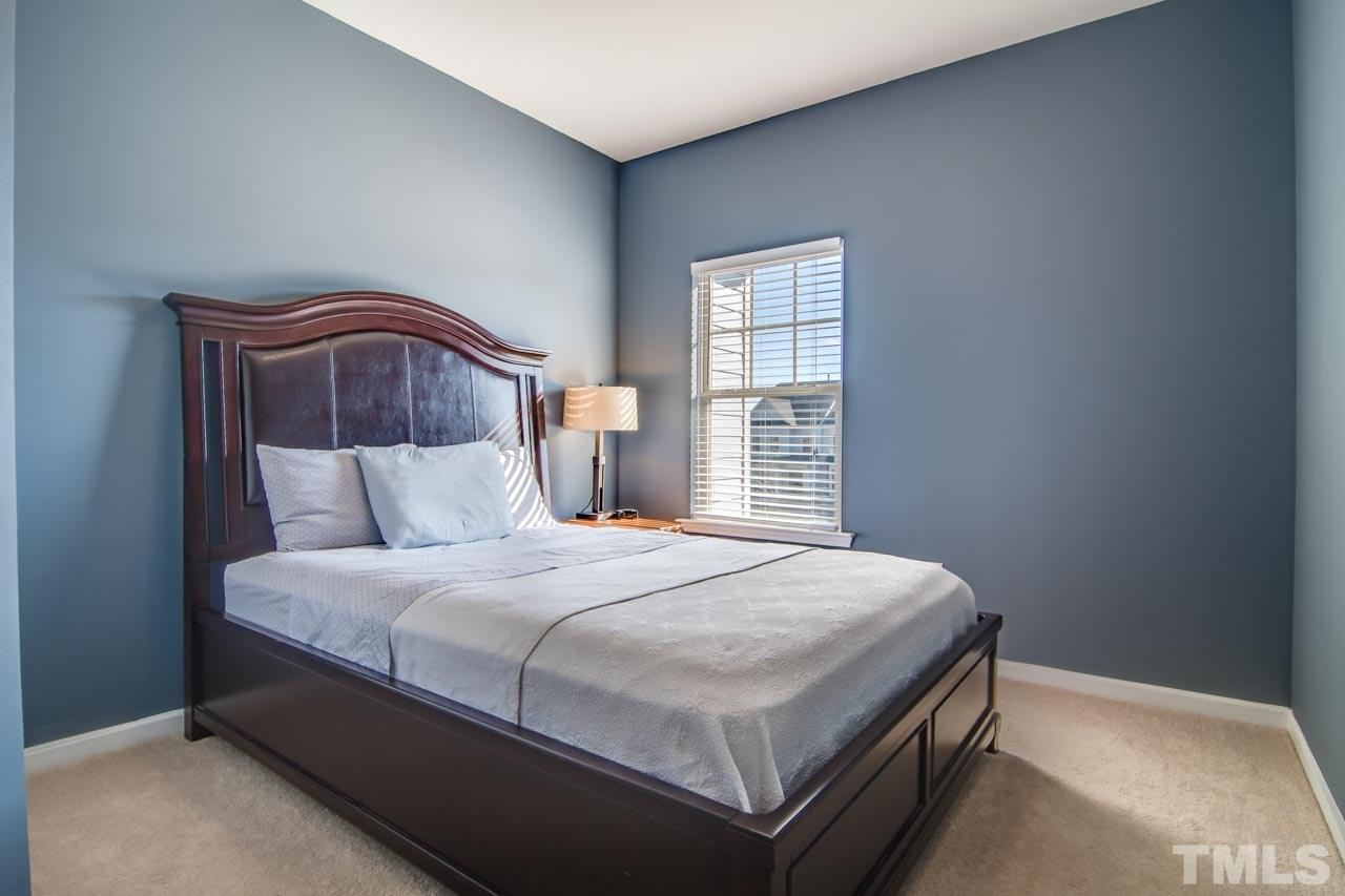1308 Cornell Place Raleigh, NC 27607 - Photo 17 of 25 a bedroom with a bed and a window