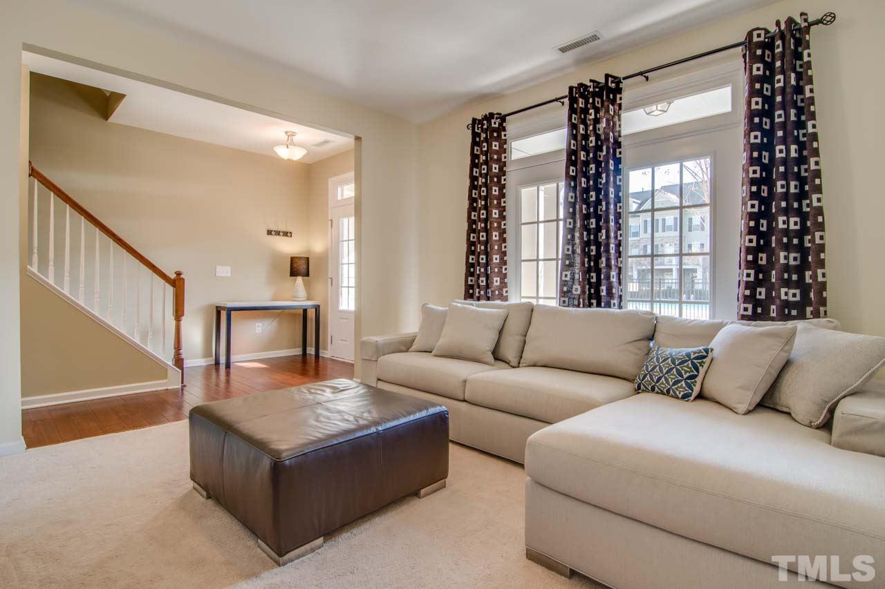 1308 Cornell Place Raleigh, NC 27607 - Photo 18 of 25 a living room with furniture and a potted plant
