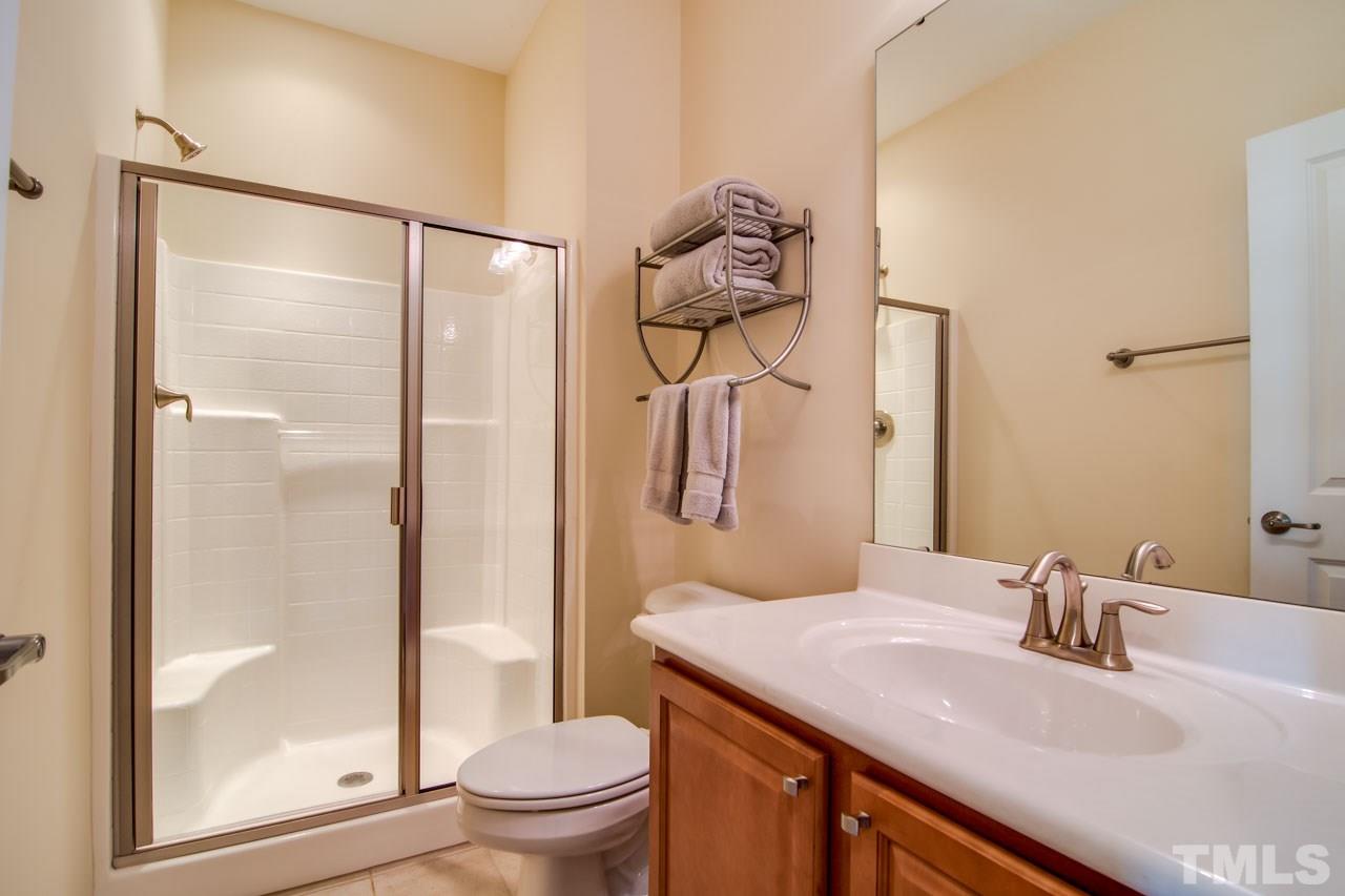 1308 Cornell Place Raleigh, NC 27607 - Photo 20 of 25 a bathroom with a granite countertop sink toilet and shower