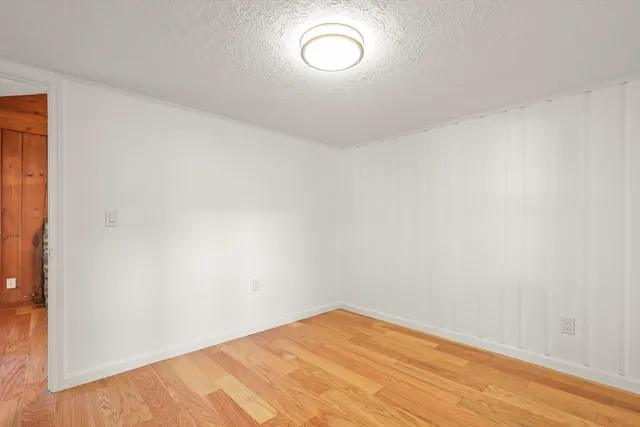 a view of a room with wooden floor and fan