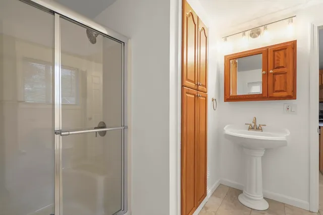 a bathroom with a sink and mirror with toilet