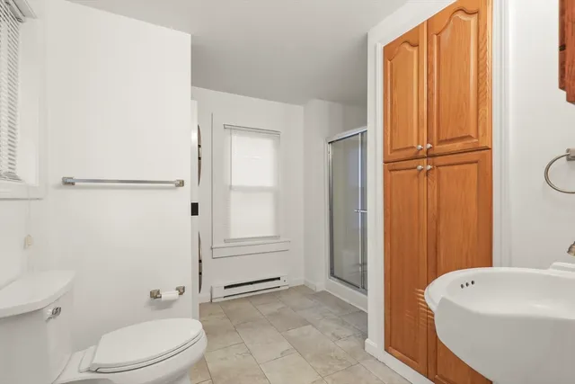 a bathroom with a toilet a sink and tub