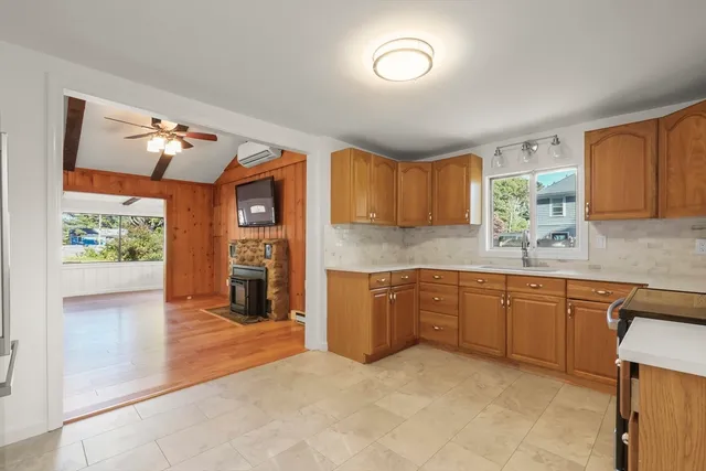 a kitchen with stainless steel appliances granite countertop a refrigerator and a stove top oven