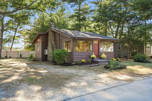 a view of a house with backyard and sitting area