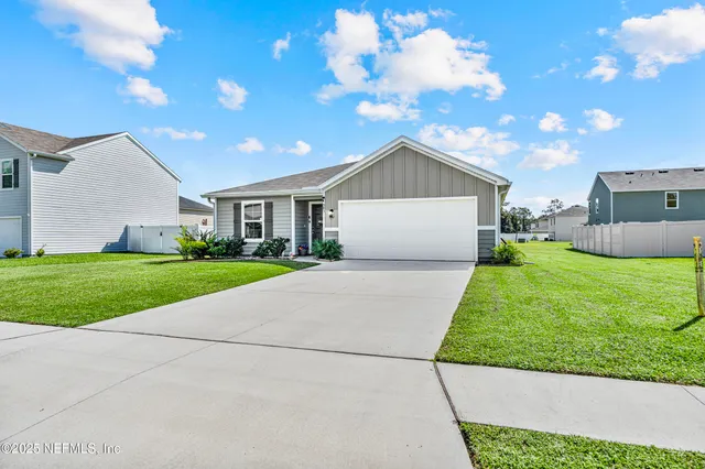 a front view of house with yard and green space