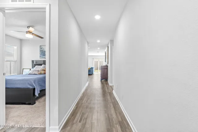 a view of hallway with wooden floor