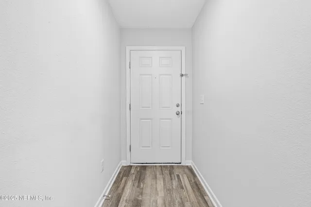 a view of a room with wooden floor and closet