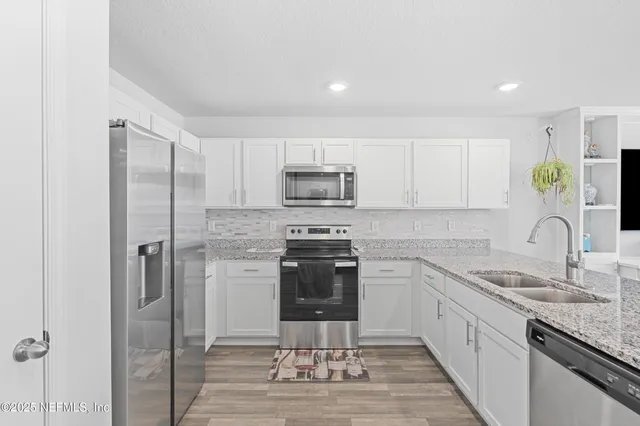 a kitchen with a sink stainless steel appliances and cabinets