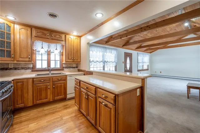 a kitchen with stainless steel appliances granite countertop a stove a sink dishwasher and a refrigerator