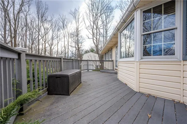 a view of backyard with deck and wooden floor