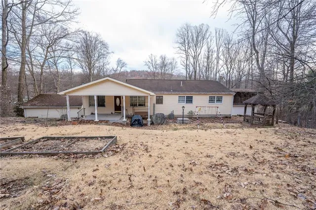 a front view of a house with a yard covered with snow