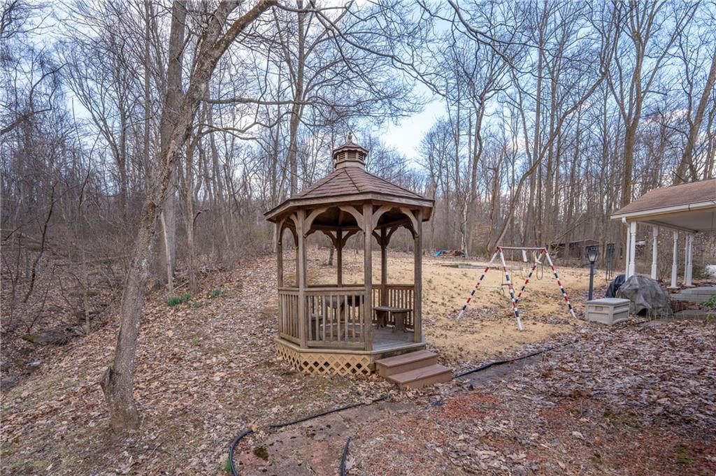 4416 Highway 819 Avonmore, PA 15618 - Photo 41 of 46 a table and chairs under an umbrella in a yard