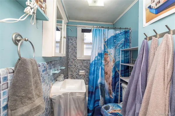 a bathroom with a sink a mirror and shower