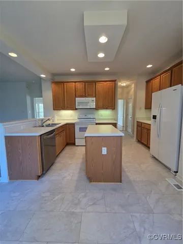 an empty room with windows and fireplace