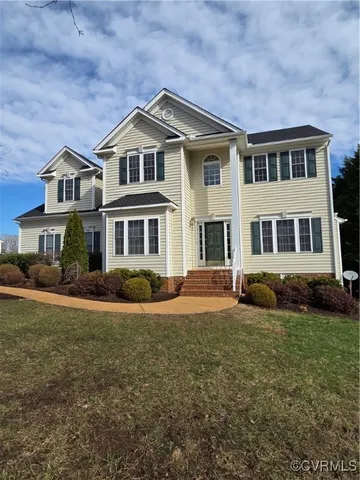 a view of a house with a flower garden