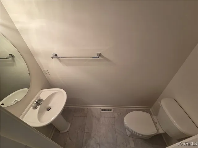 a white toilet sitting next to a shower