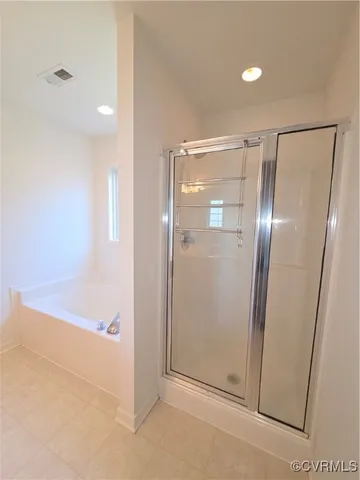 a bedroom with a bed couch and window