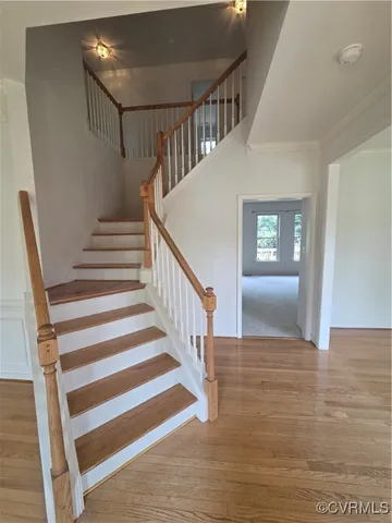 a living room with furniture wooden floor and a large window