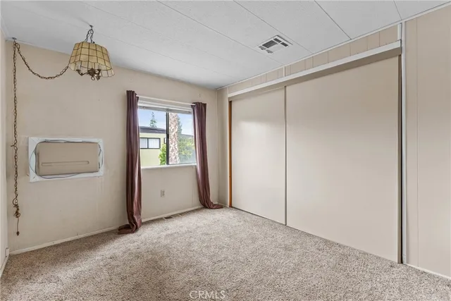 a bathroom with a granite countertop toilet sink and mirror