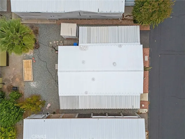 a view of a patio with table and chairs under an umbrella