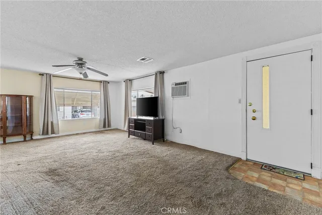 a view of a livingroom with a flat screen tv and windows