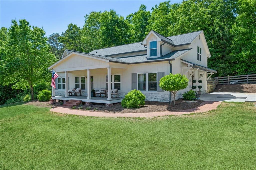 7975 Wallace Tatum Road Cumming, GA 30028 - Photo 1 of 1 a view of a house with a yard and sitting area