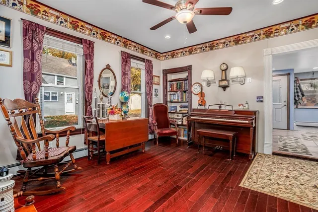 a living room with furniture and a wooden floor