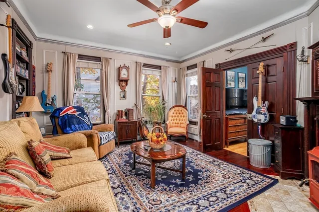 a living room with furniture a rug and a chandelier