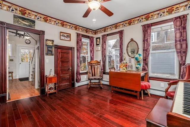 a living room with furniture and wooden floor