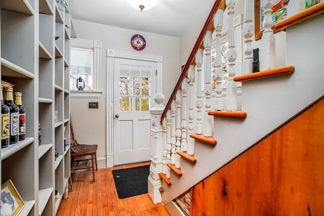 a view of entryway and hall with wooden floor