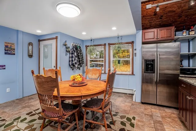 a dining room with furniture and window