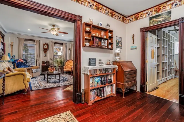 a living room with furniture and a book shelf