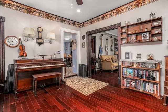 a living room with furniture and a book shelf
