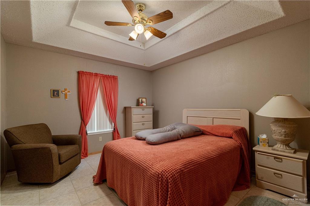 1717 Sun Street Mission, TX 78572 - Photo 14 of 19 a bedroom with a bed and a couch
