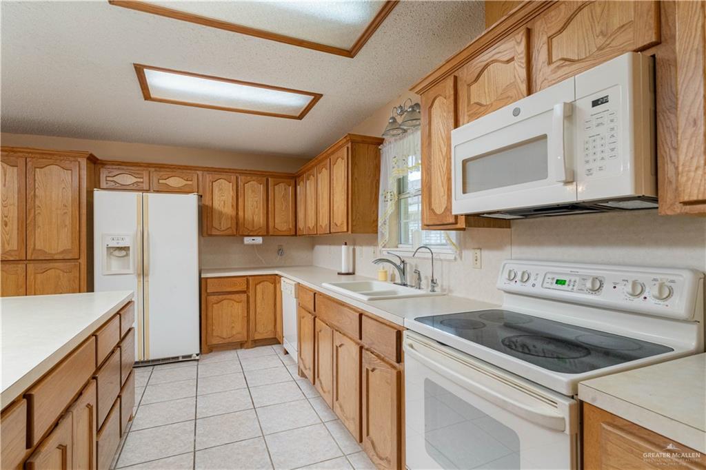 1717 Sun Street Mission, TX 78572 - Photo 6 of 19 a kitchen with a sink stove and cabinets