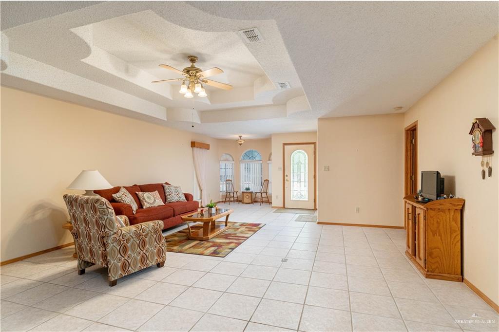 1717 Sun Street Mission, TX 78572 - Photo 8 of 19 a living room with furniture and a chandelier