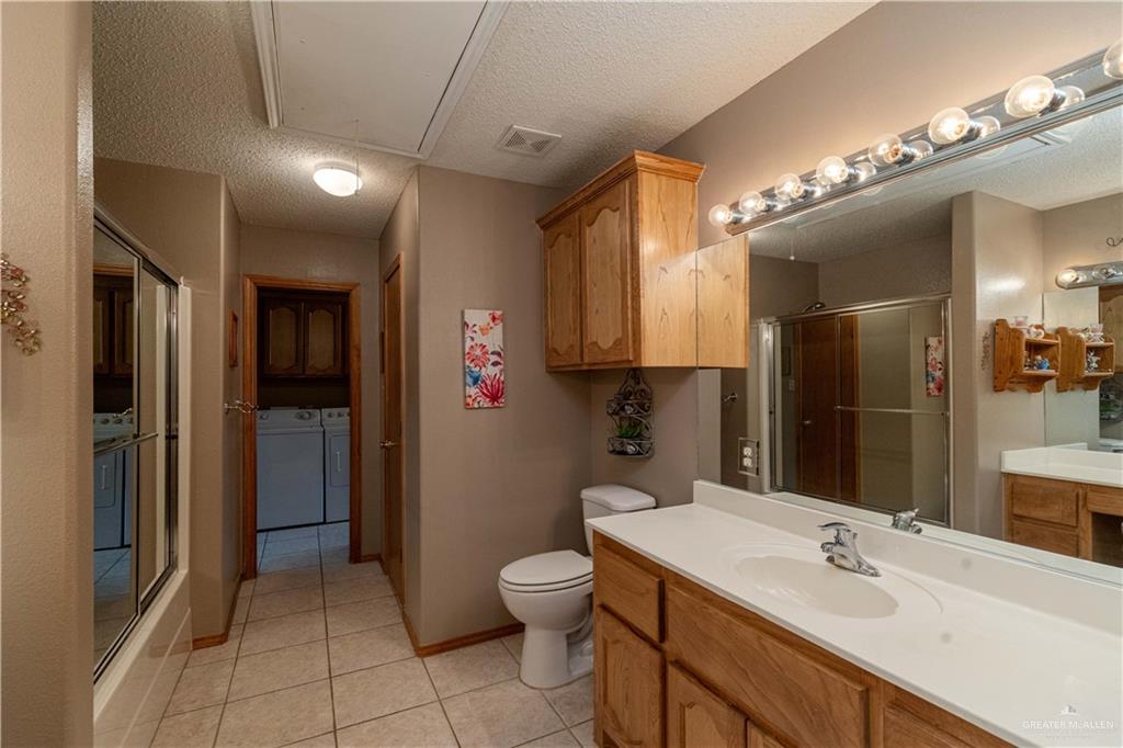 1717 Sun Street Mission, TX 78572 - Photo 9 of 19 a bathroom with a toilet sink and mirror