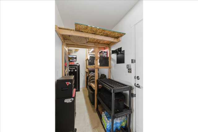 370 West Knights Lane Layton, UT 84041 - Photo 31 of 31 Dedicated storage area featuring built-in wooden shelving, a white interior door, and a light-colored floor