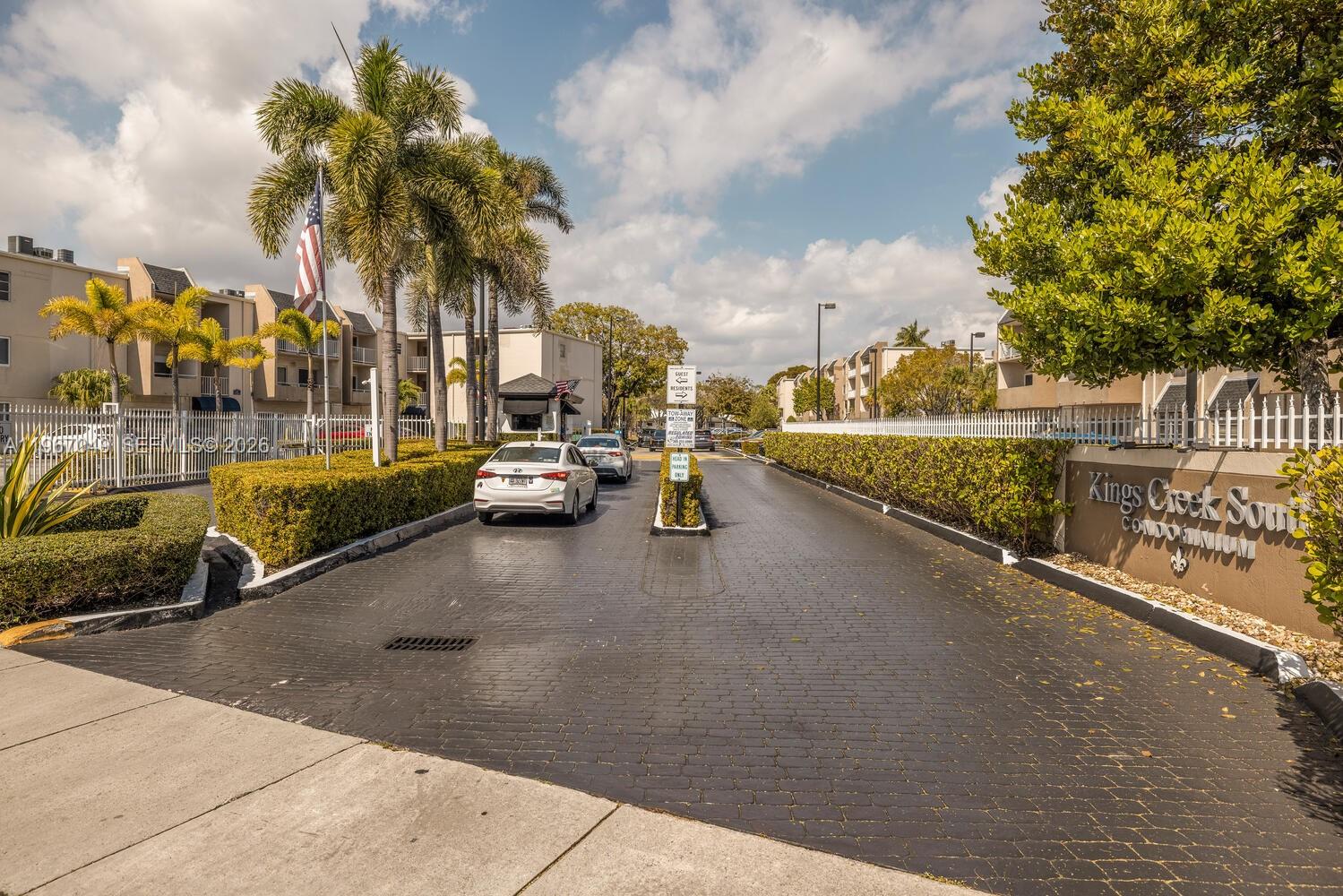 7785 Southwest 86th Street, Unit E119 Miami, FL 33143 - Photo 1 of 33 a view of a city street with a building and trees in the background