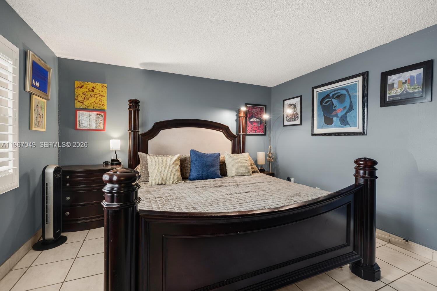 7785 Southwest 86th Street, Unit E119 Miami, FL 33143 - Photo 11 of 33 a bedroom with a bed and dresser