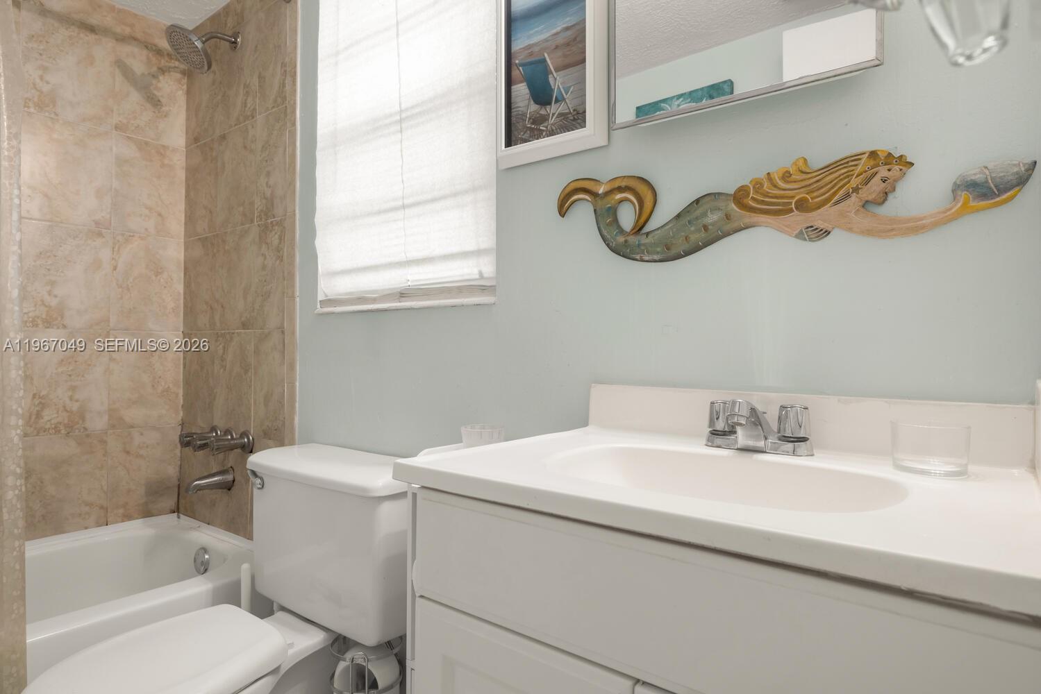 7785 Southwest 86th Street, Unit E119 Miami, FL 33143 - Photo 14 of 33 a bathroom with a sink and a toilet